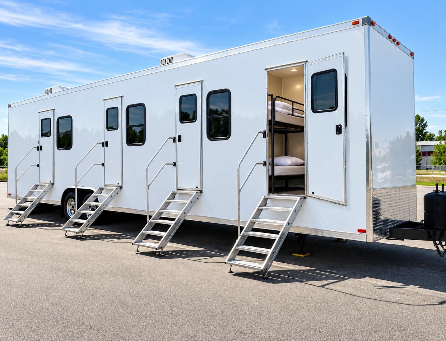 White accommodation trailer exterior with entry doors and windows