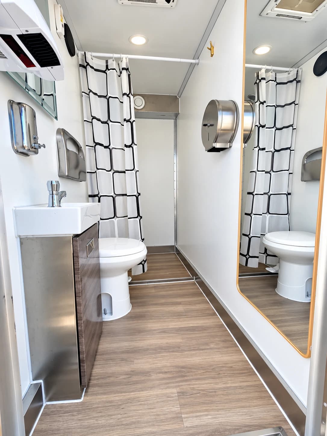 Shower and restroom interior with toilets, sinks and curtained washing areas