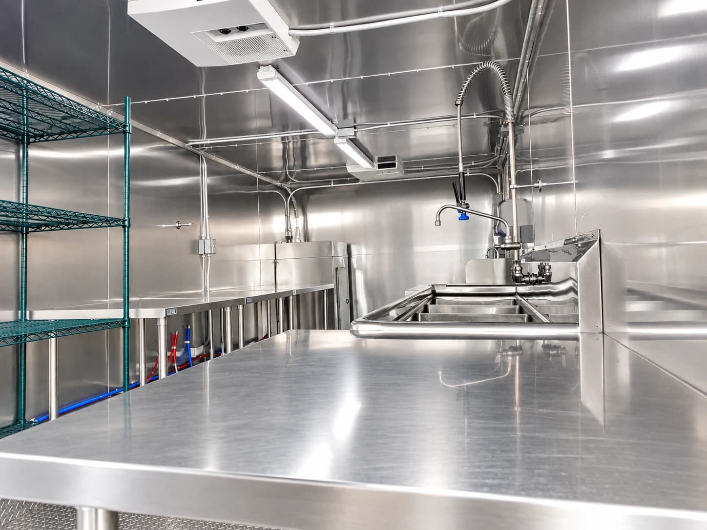 Stainless-steel work area inside a commercial dishwashing trailer