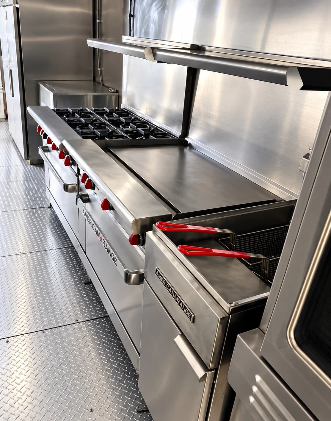Commercial cooking line with a gas range, flat griddle and fryer baskets